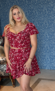 Female therapist wearing a red floral dress at Najma Signature Spa